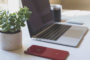 MacBook with iPhone next to it ATS Connection