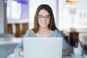 women smiling on mac