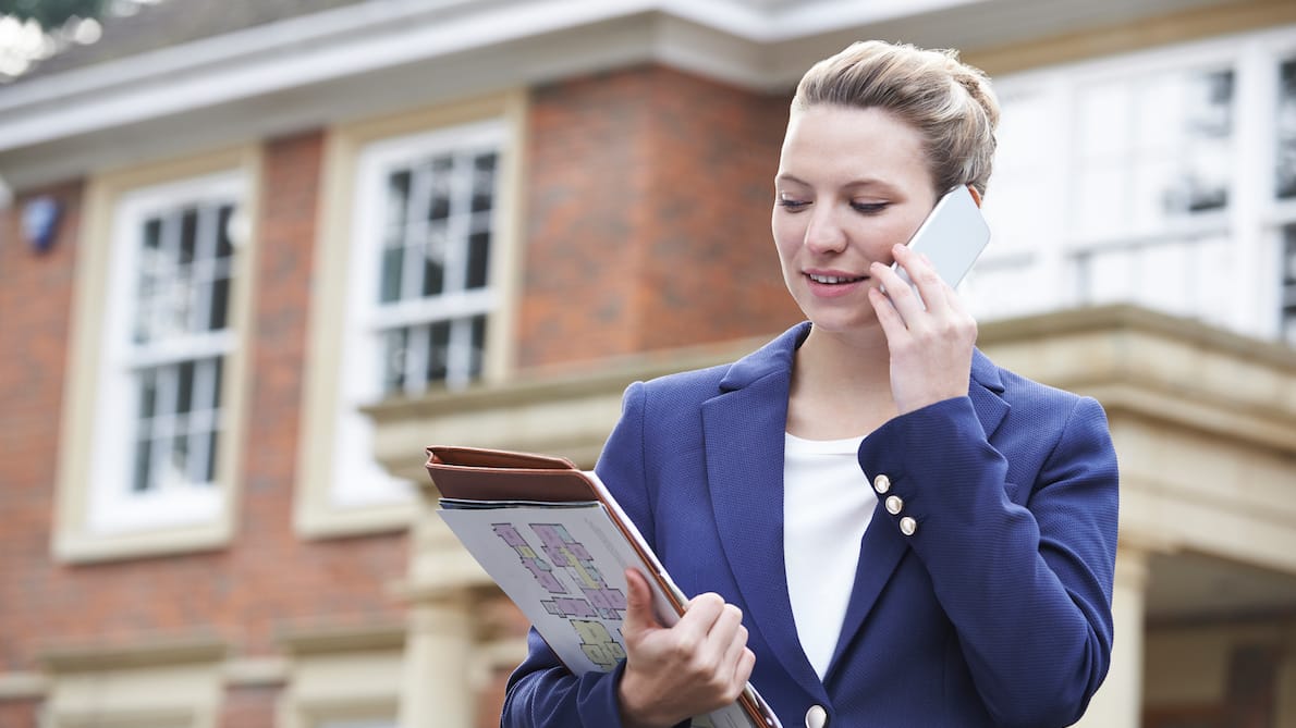 Estate agent on mobile phone