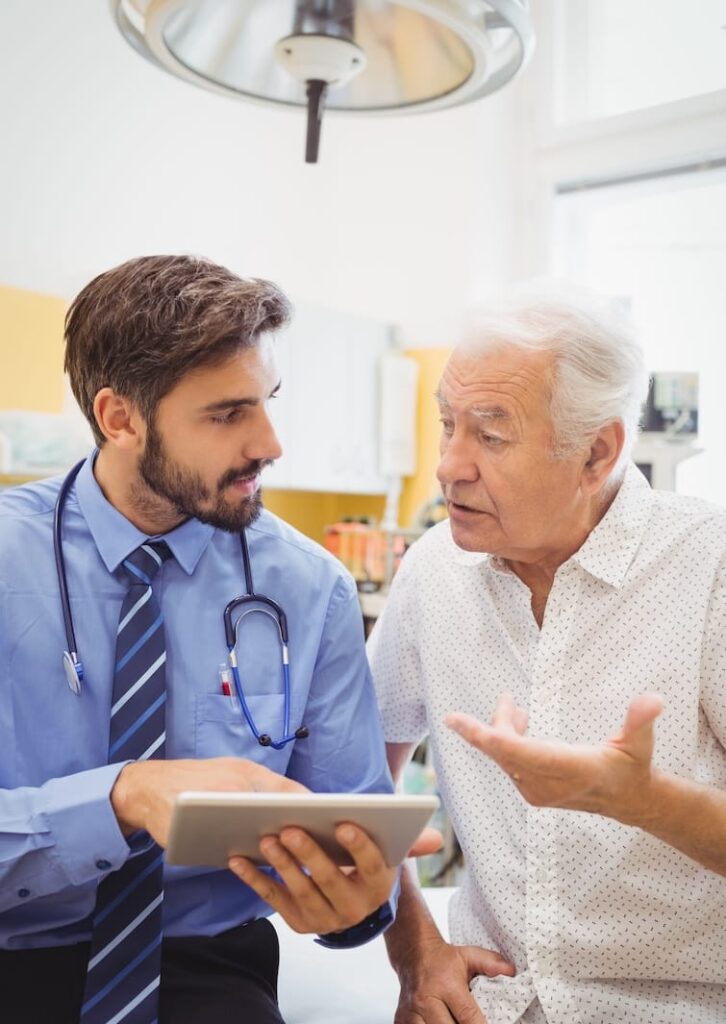 Doctor showing patient information on ipad