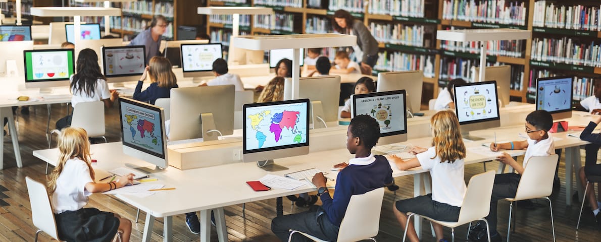 Kids learning on iMacs